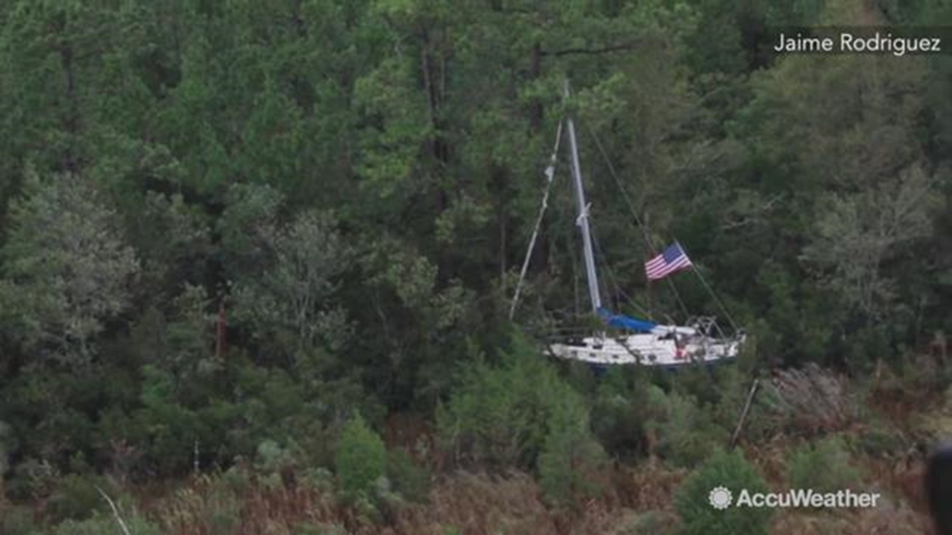 A helicopter survey conducted by US Customs and Border Protection on September 16 shows this boat washed into a wooded area from Hurricane Florence in Raleigh, NC.