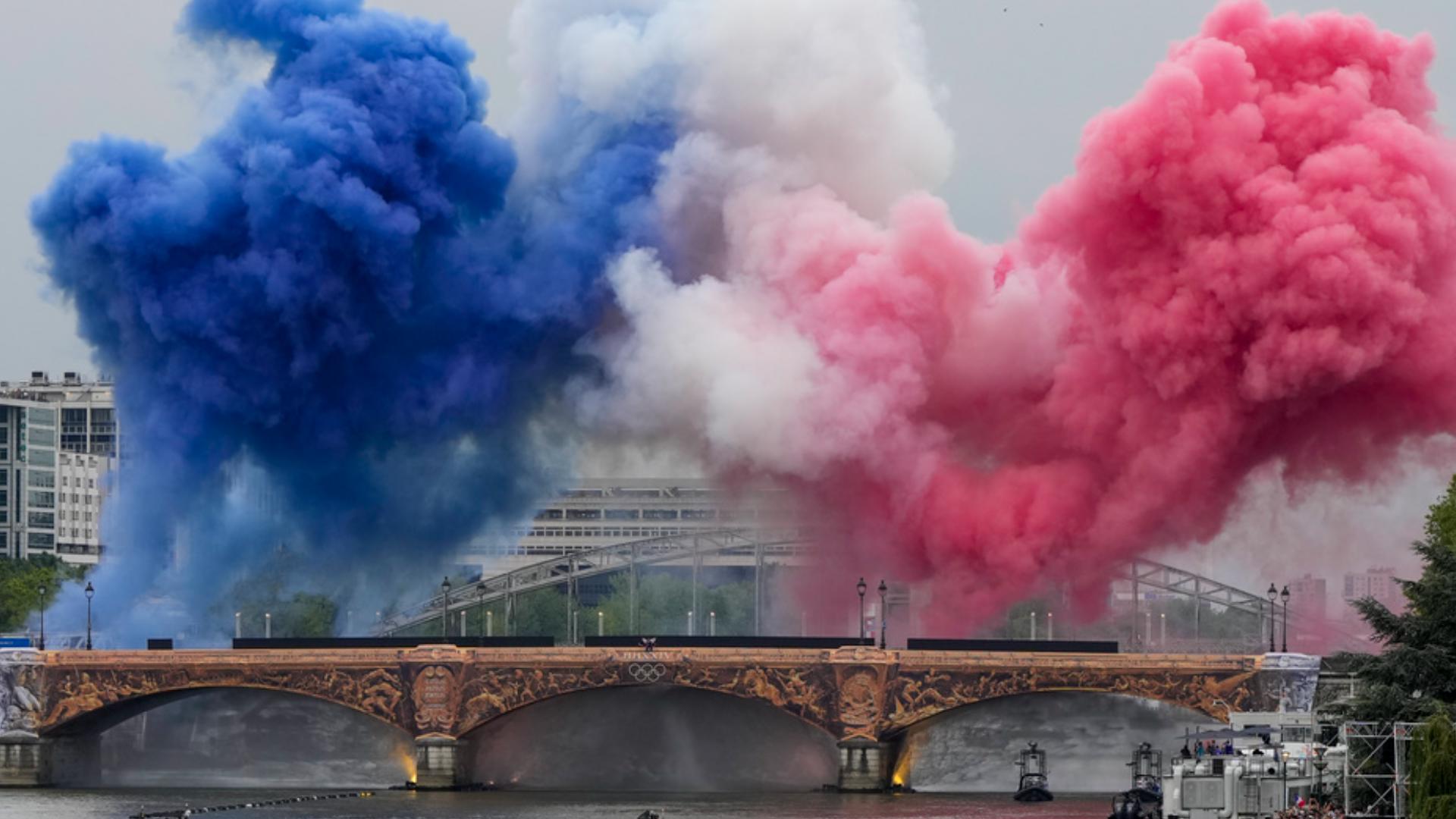 A hot-air balloon brought an Olympic ring of fire into a rainy sky and singer Celine Dion belted from the Eiffel Tower as Paris kicked the Summer Olympics.
