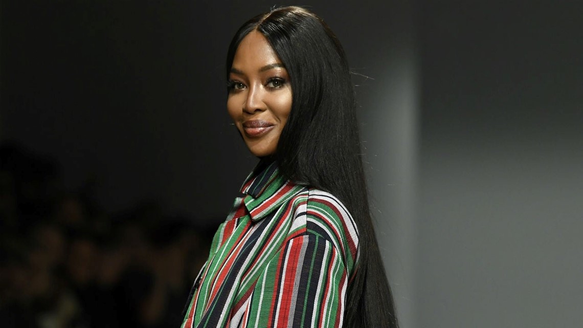 British supermodel Naomi Campbell poses next to the travel case