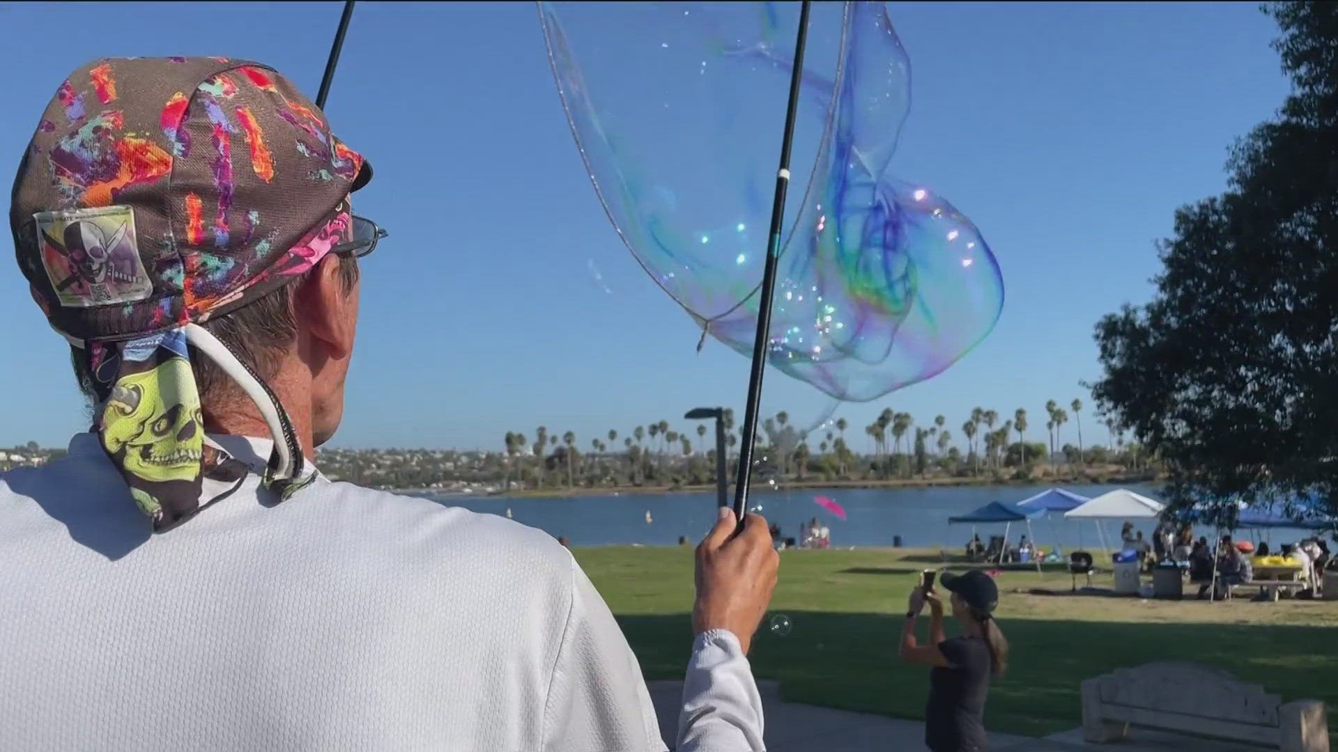 Sandy Snakenburg, a homeless veteran known for bubble blowing in La Jolla Cove, was issued a citation by a San Diego park ranger.