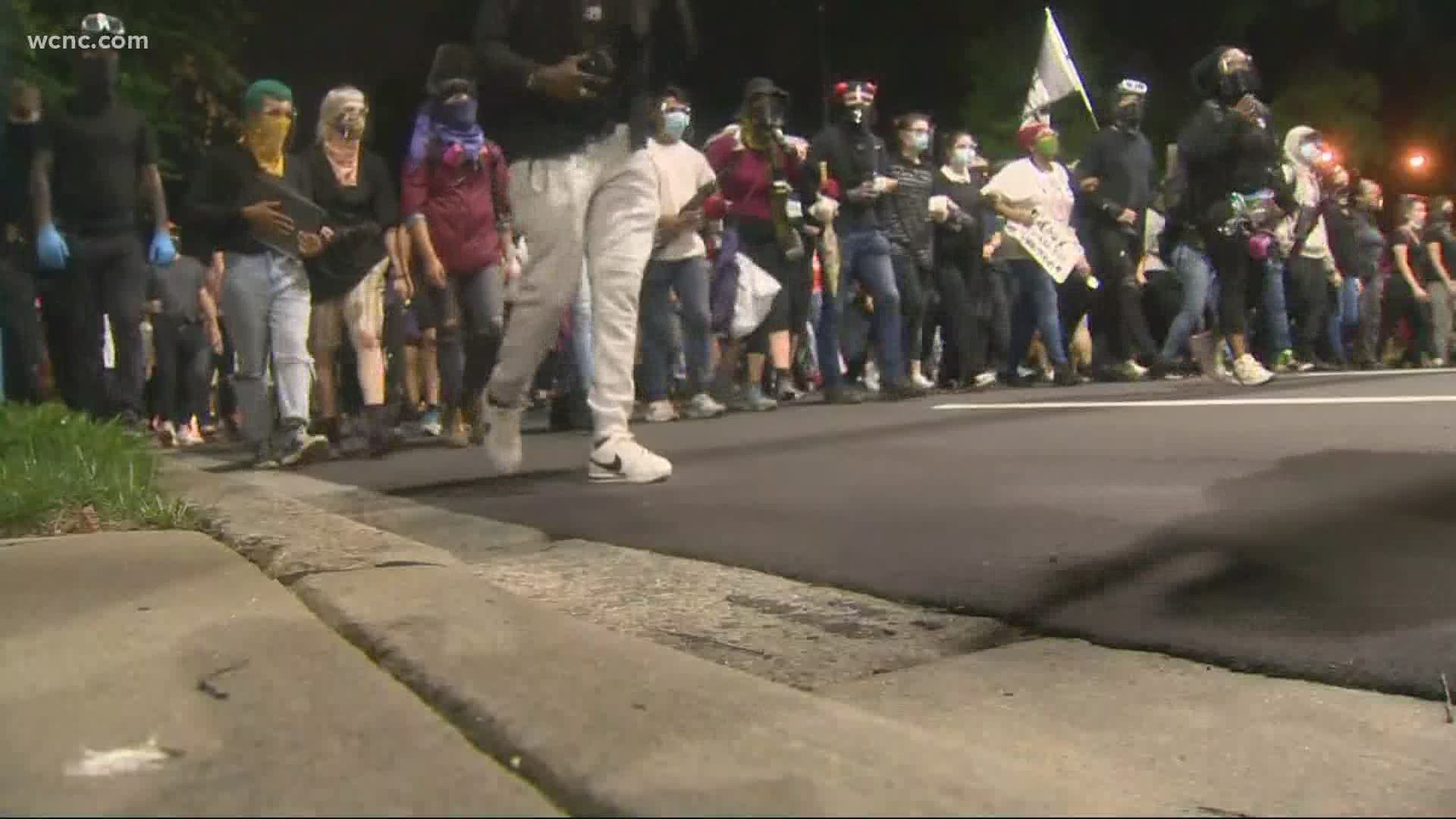 Charlotte-Mecklenburg Police said two protesters were hurt when officers deployed tear gas to disperse crowds Monday night.