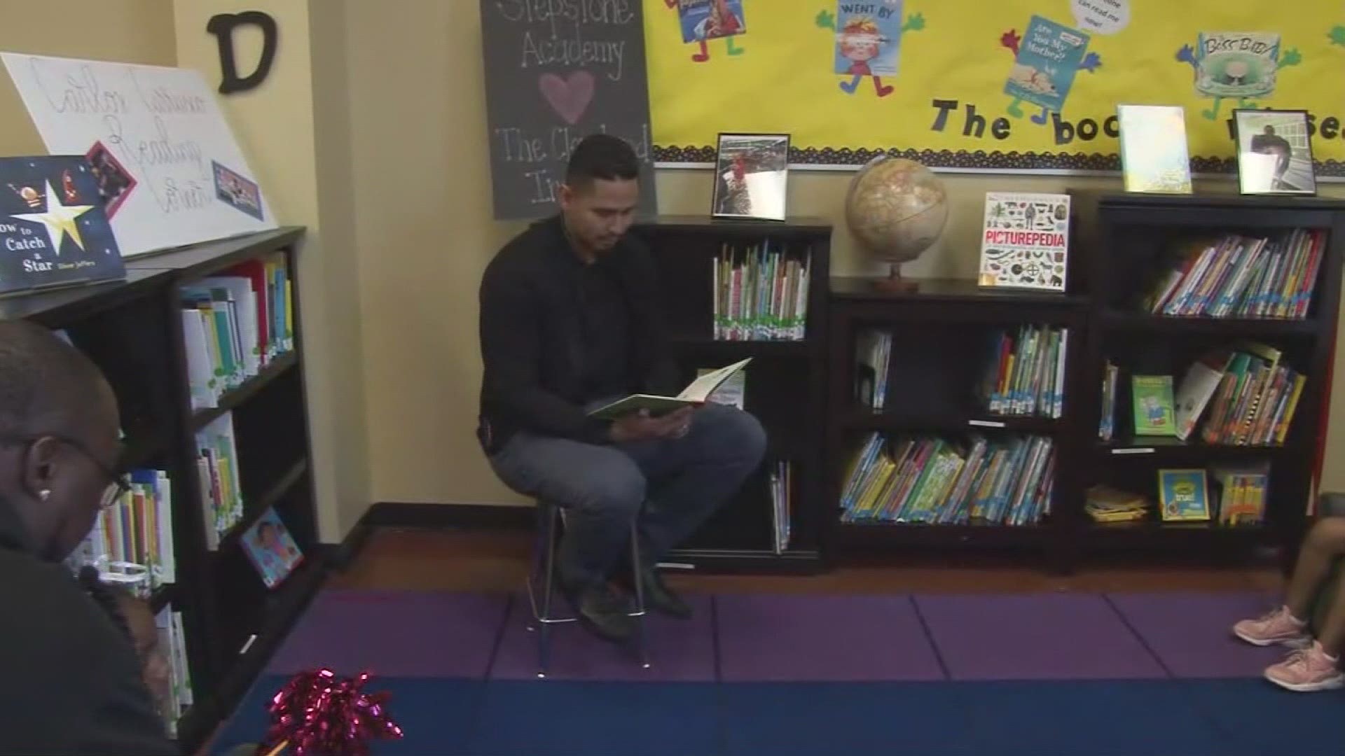 Cleveland Indians pitcher Carlos Carrasco reads "If You Give A Mouse A Cookie" to Cleveland students.