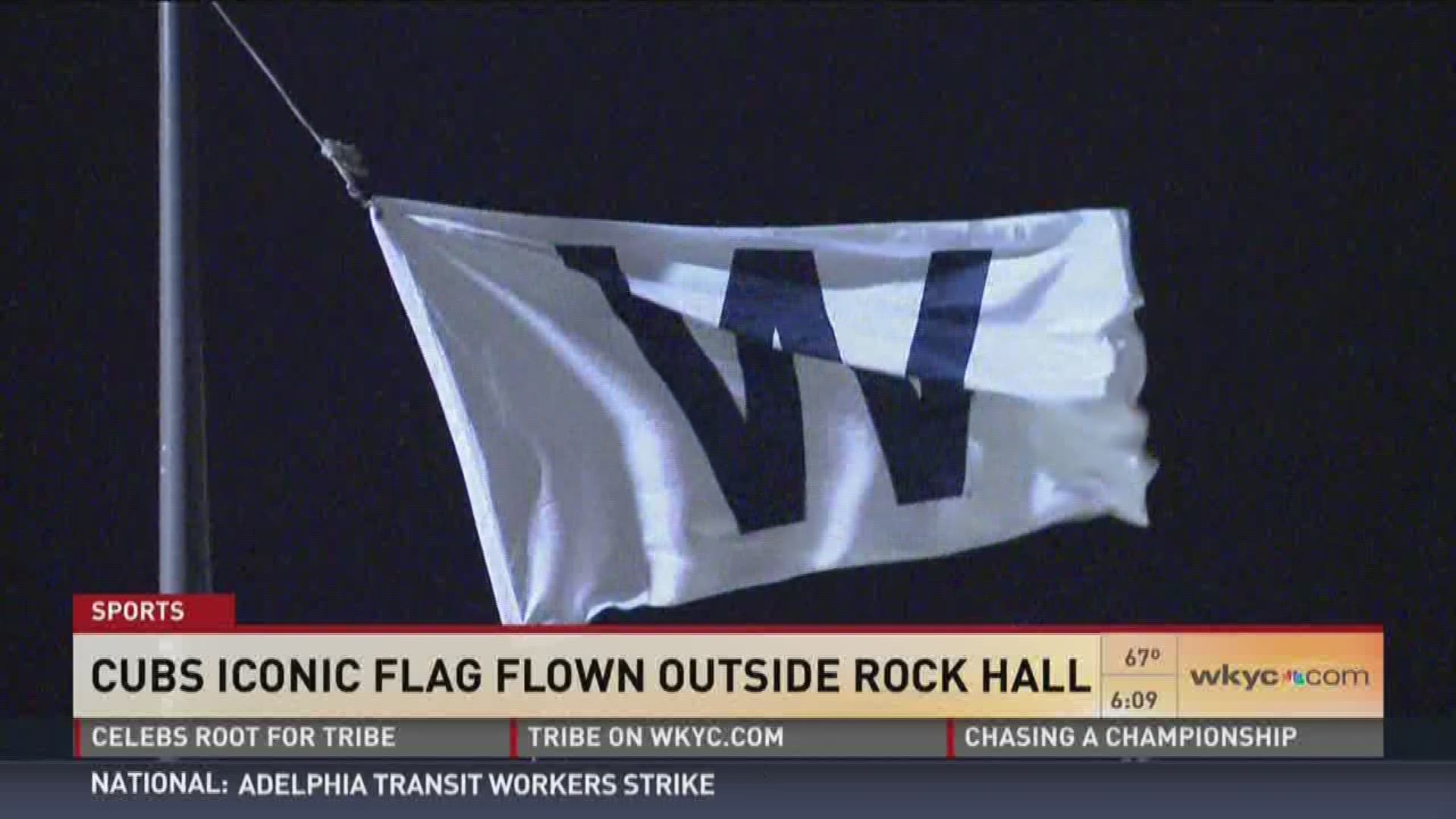 Chicago Cubs fan raises 'W' flag above Rock and Roll Hall of Fame