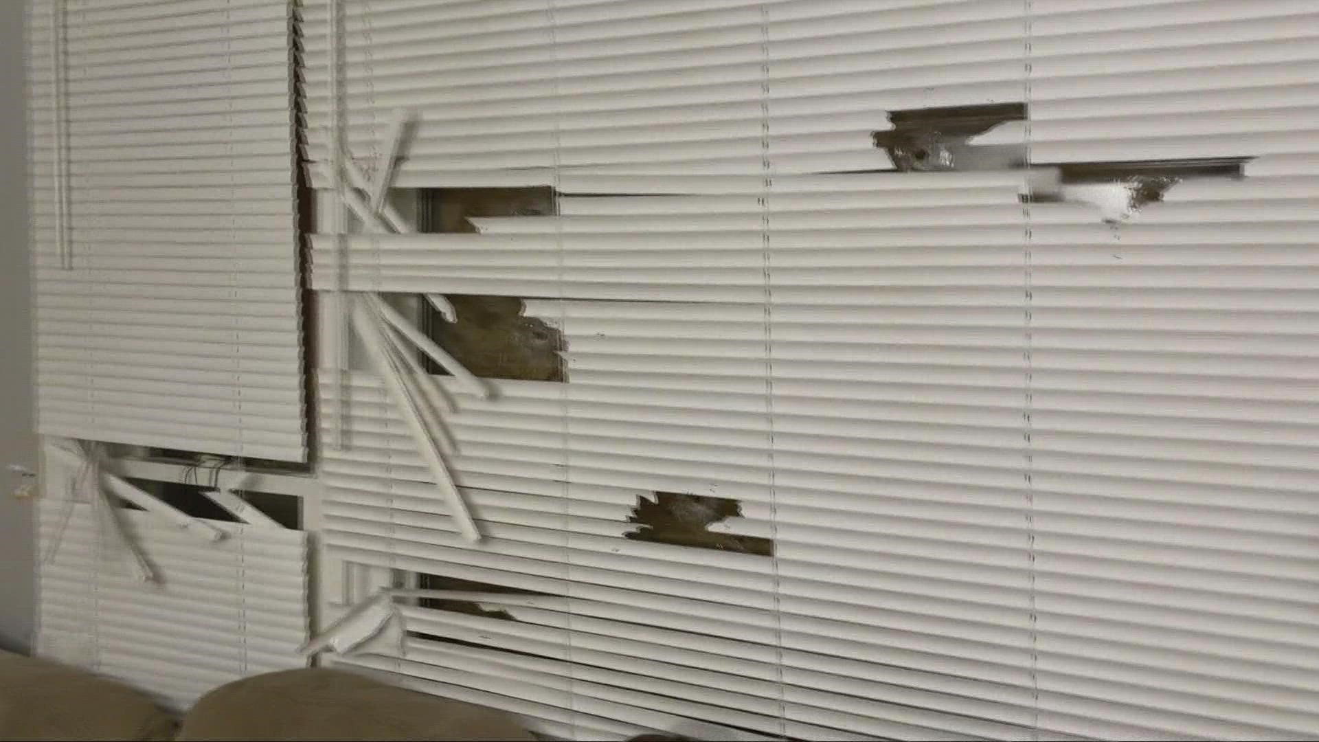 Nearly three dozen shots struck the home following an incident outside. One woman inside was grazed on the foot.