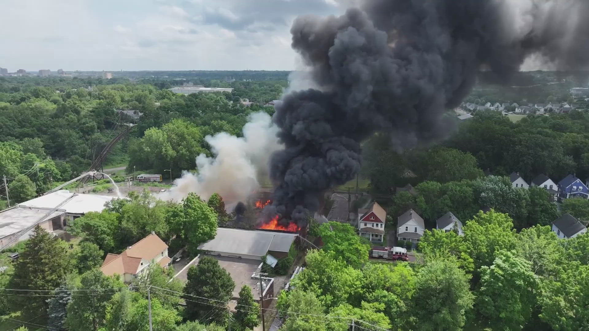Monday's fire at a warehouse on East 65th Street and Selma Avenue injured two members of the Cleveland Division of Fire and also damaged a nearby home.