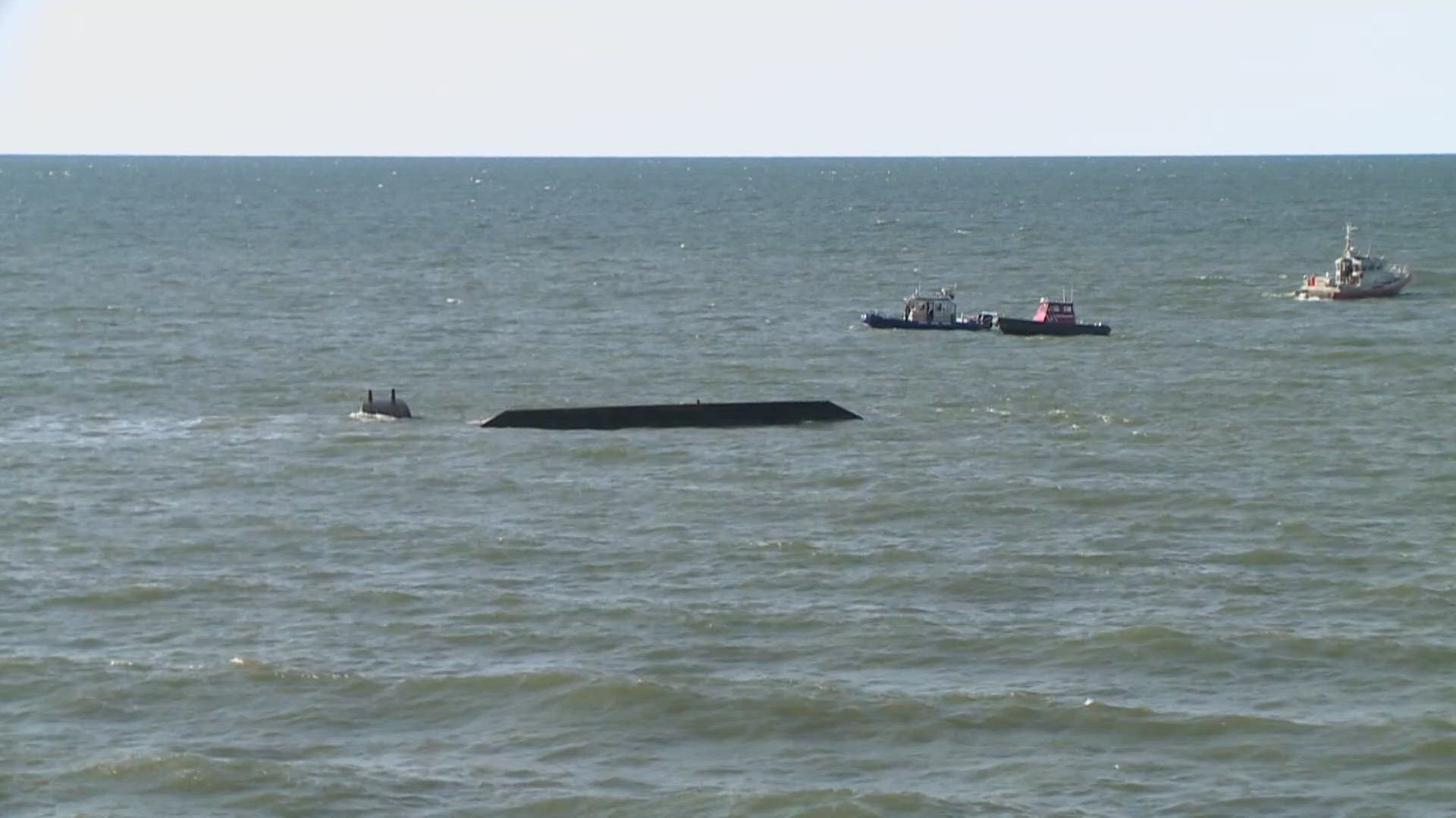 Officials say no one was injured, but an oil sheen remains on the lake after multiple barrels fell into the water. An investigation into the incident is underway.