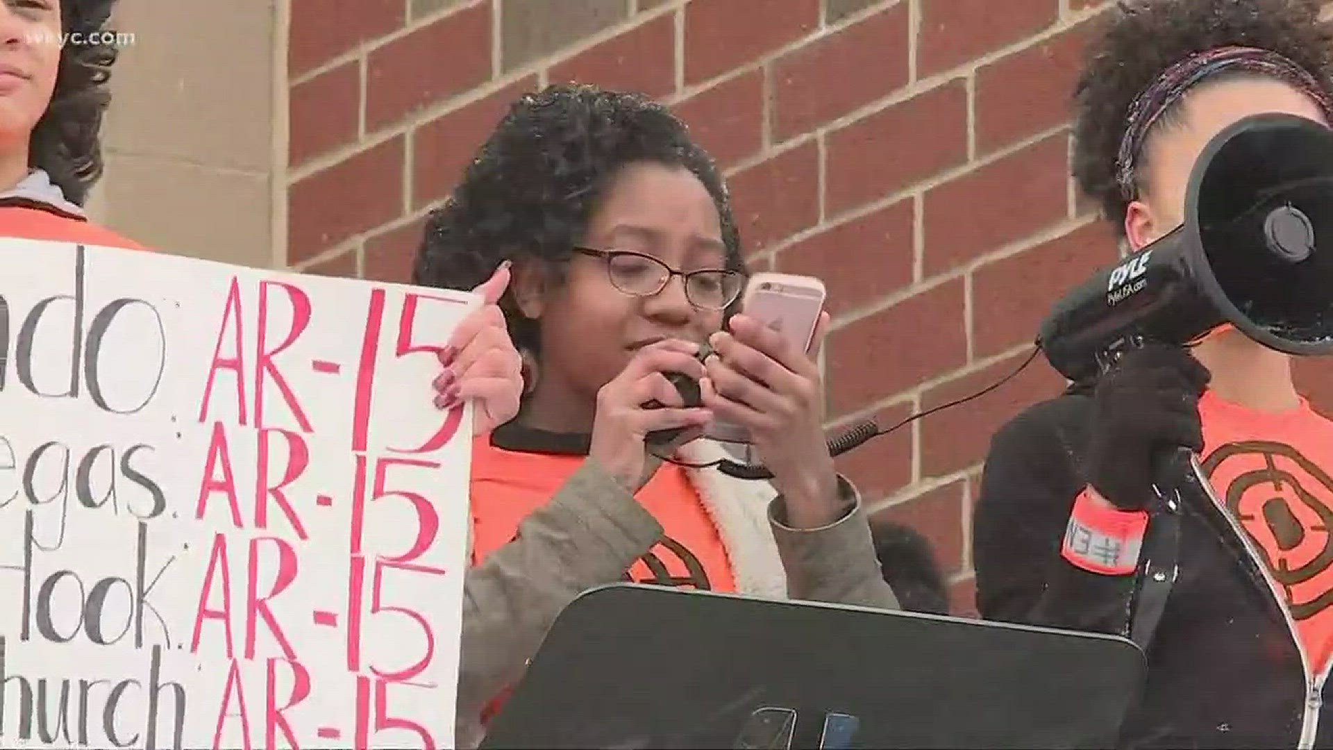 Akron Firestone students wear orange shirts with targets during walkout