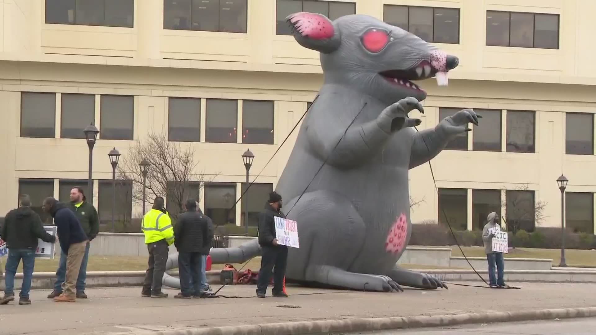 Flanked by two inflatable rats, the workers held a series of signs with different messages protesting conditions at the Cuyahoga County Juvenile Justice Center.