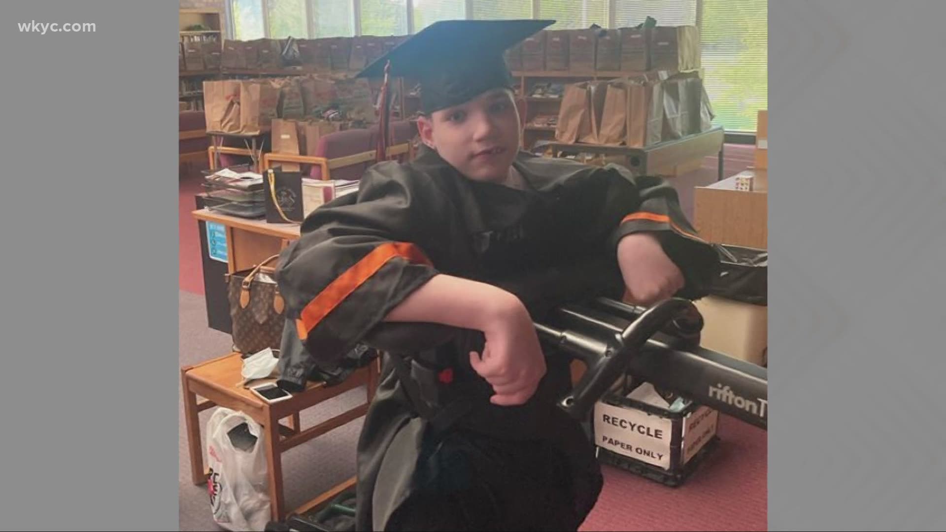 Wheelchairbound student walks at Hoover High School graduation