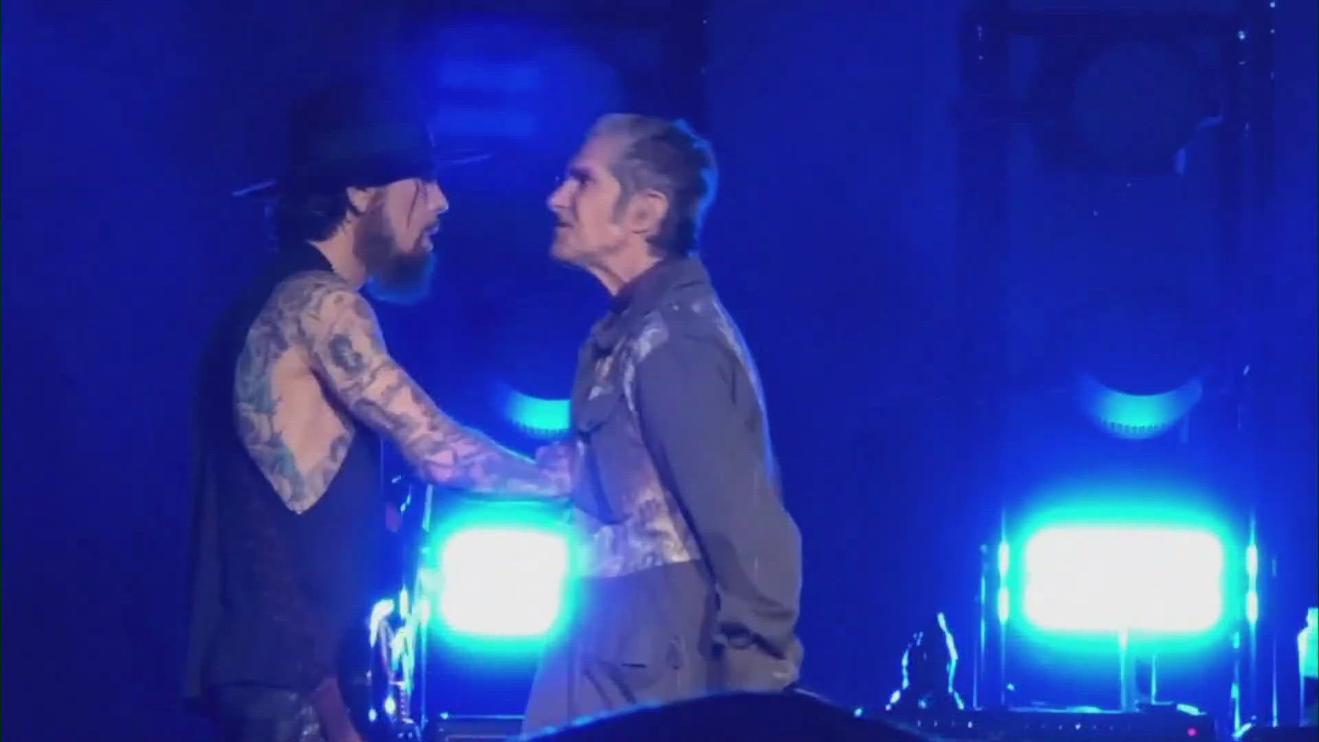 Singer Perry Farrell threw a punch at guitarist Dave Nevarro onstage before being restrained by concert crew in Boston. The show was shut down after the incident.