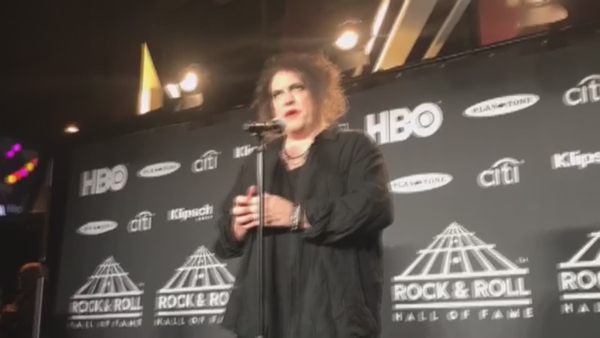 Robert Smith of The Cure talks backstage at Rock & Roll Hall of Fame induction ceremony