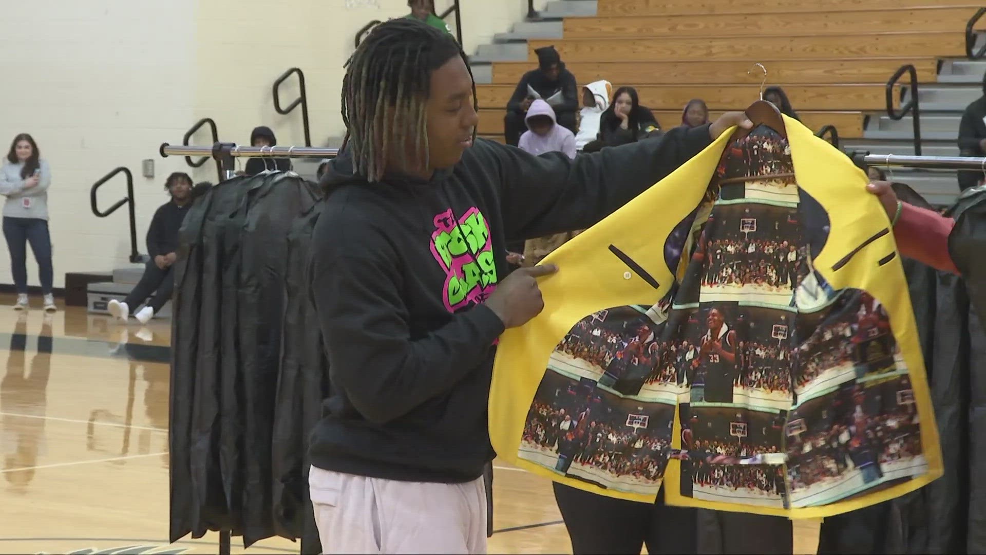 Akron native Travaughn Gordon gifted 18 custom-made suits to the members of Buchtel's basketball team, as well as Anthony Anderson, who was injured in a shooting.