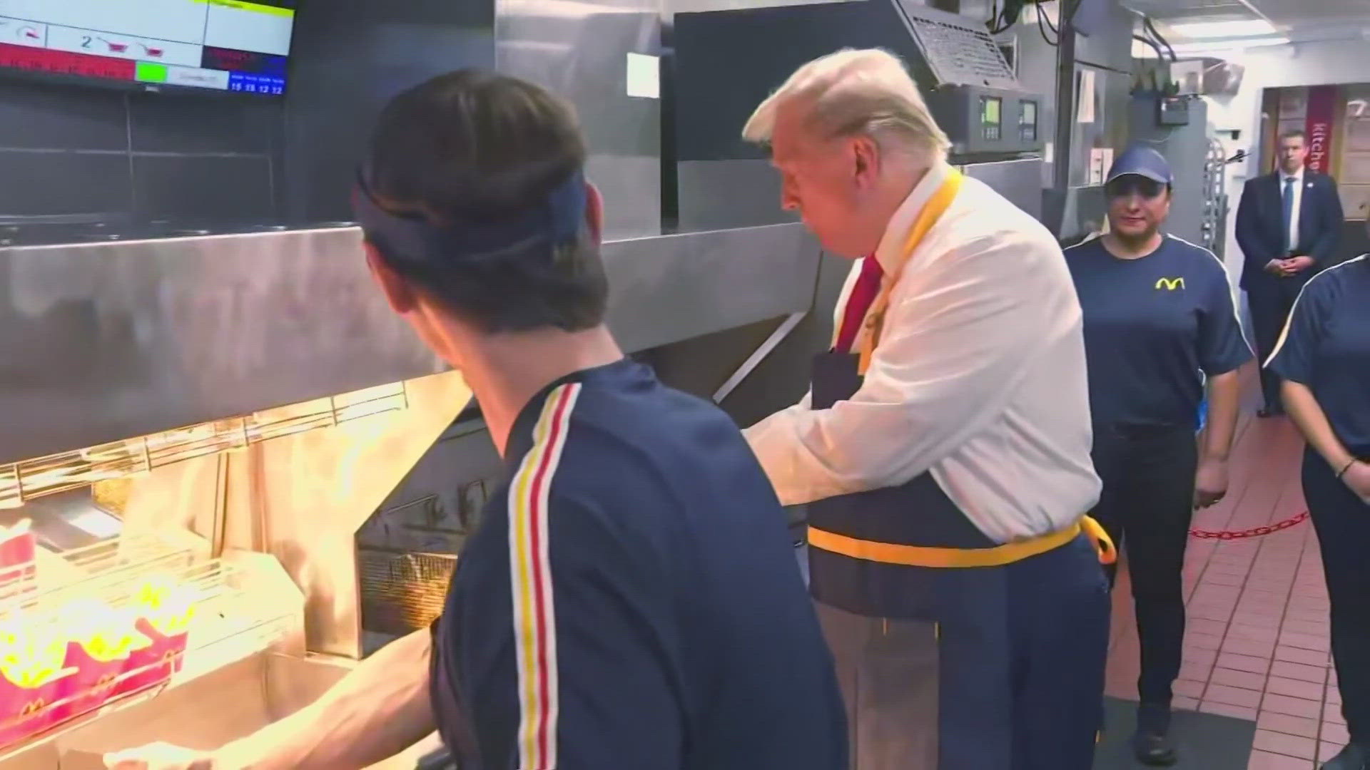 An employee showed former President Trump how to dunk baskets of fries in oil, salt the fries and put them into boxes using a scoop.