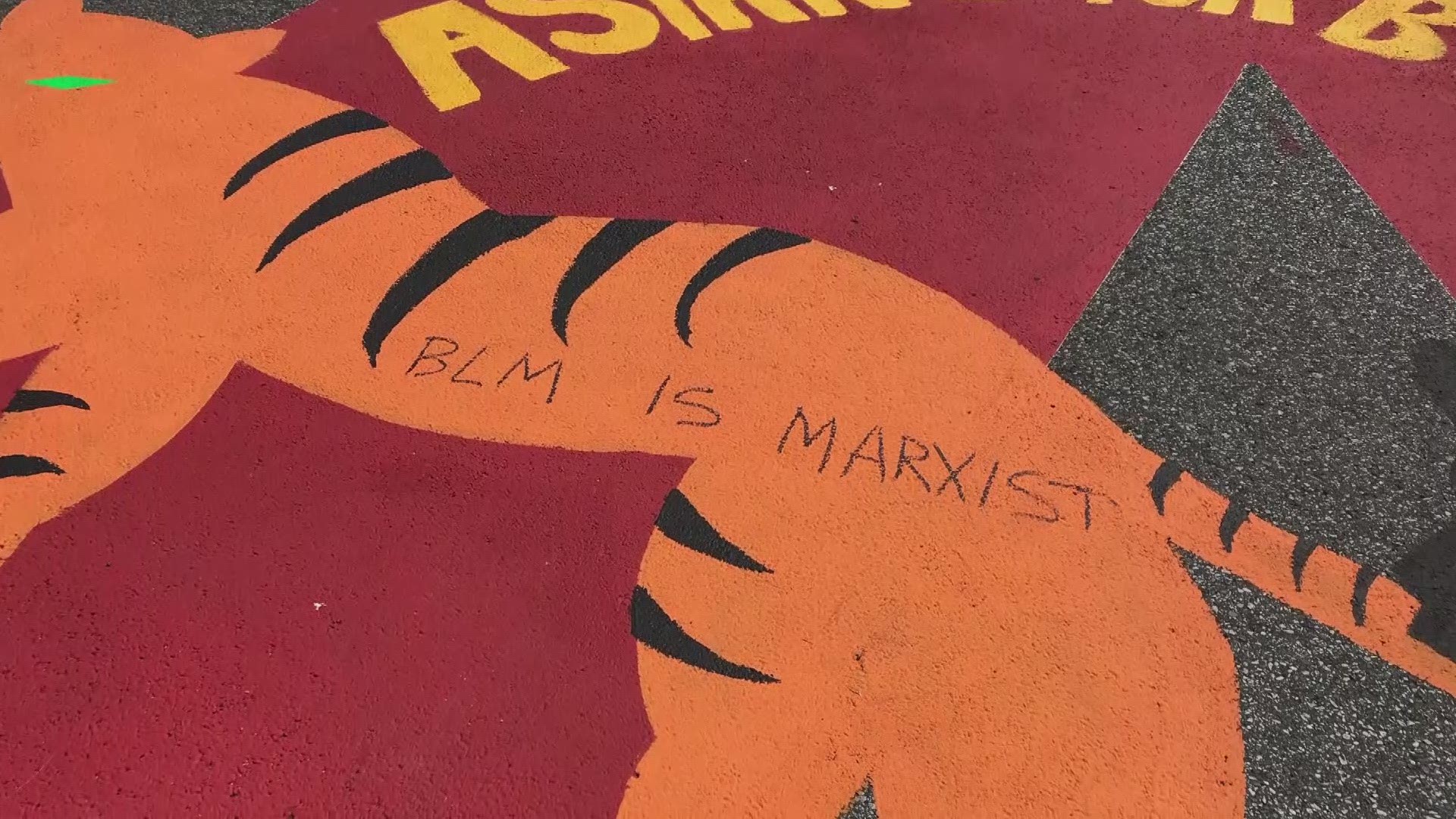 3News captured images of the vandalism Tuesday morning that shows the words "BLM IS MARXIST" and "STOP KILLING EACH OTHER" were written on top of the street mural.