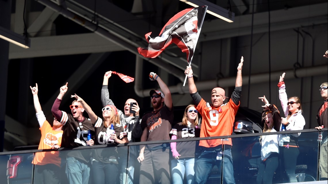 UFC Heavyweight Champion Stipe Miocic, orange jersey, waves Ohio's