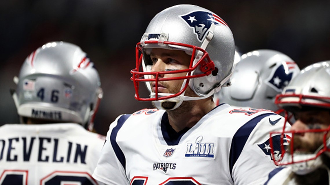 New England Patriots' Tom Brady (12) passes under pressure form Los Angeles  Rams' Aaron Donald (99) during the first half of the NFL Super Bowl 53  football game Sunday, Feb. 3, 2019